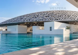 Louvre Abu Dhabi museum dome rising over the waterfront.